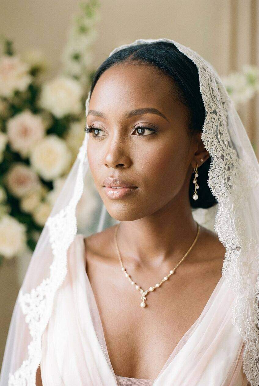 Bride in a lace veil with soft natural bridal makeup and pearl jewellery by She's Confident, wedding morning in Karen, Nairobi